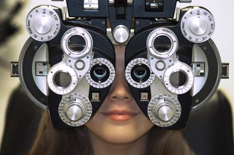 Woman's Face Behind Eye Exam Machine Lakeland FL Family Eye Center South