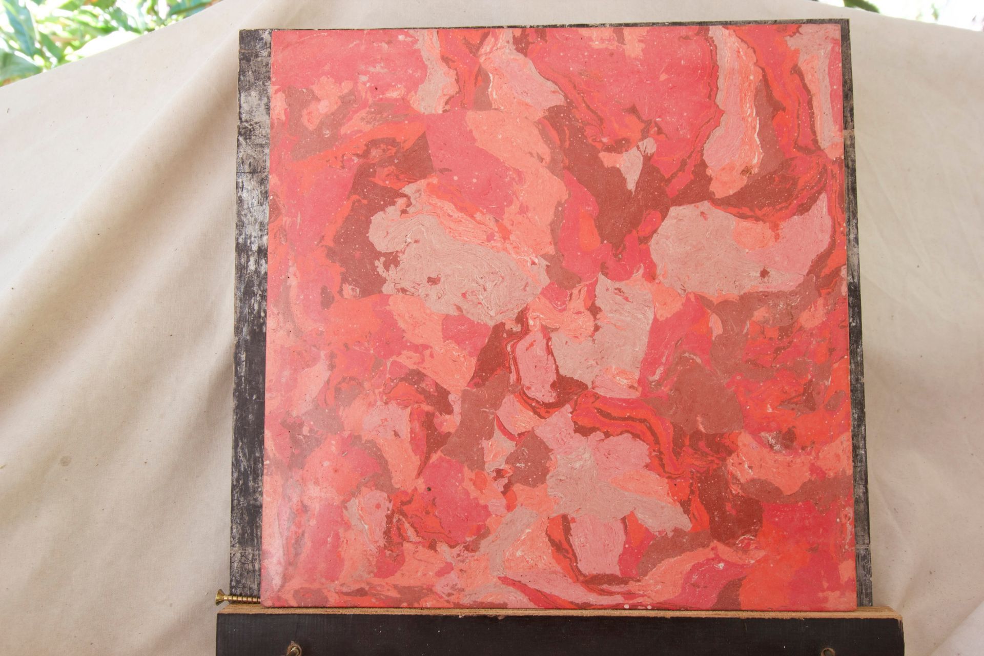 Abstract marbled painting in teal, green, gold, and black on a dark square frame — Neil Griffiths Rendering in Berry Springs, NT