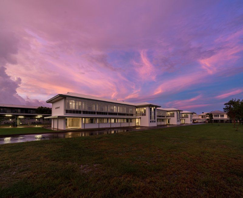 School Building at Sunset, With a Vibrant Pink and Purple Sky — Neil Griffiths Rendering in Berry Springs, NT