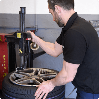 Mechanic at Budjet Tyres checking tyre pressure