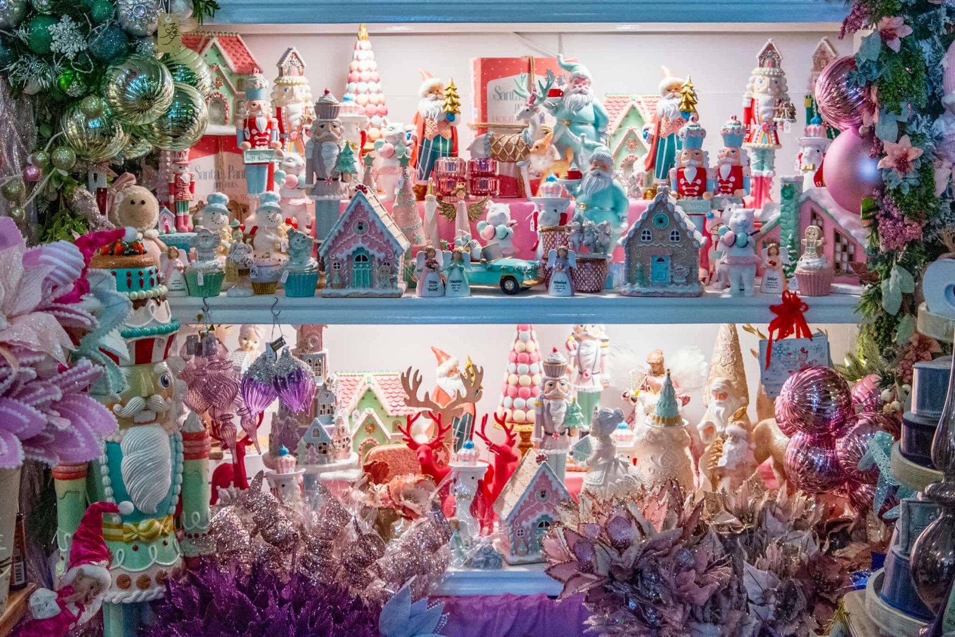 There are a lot of christmas decorations on the shelves.