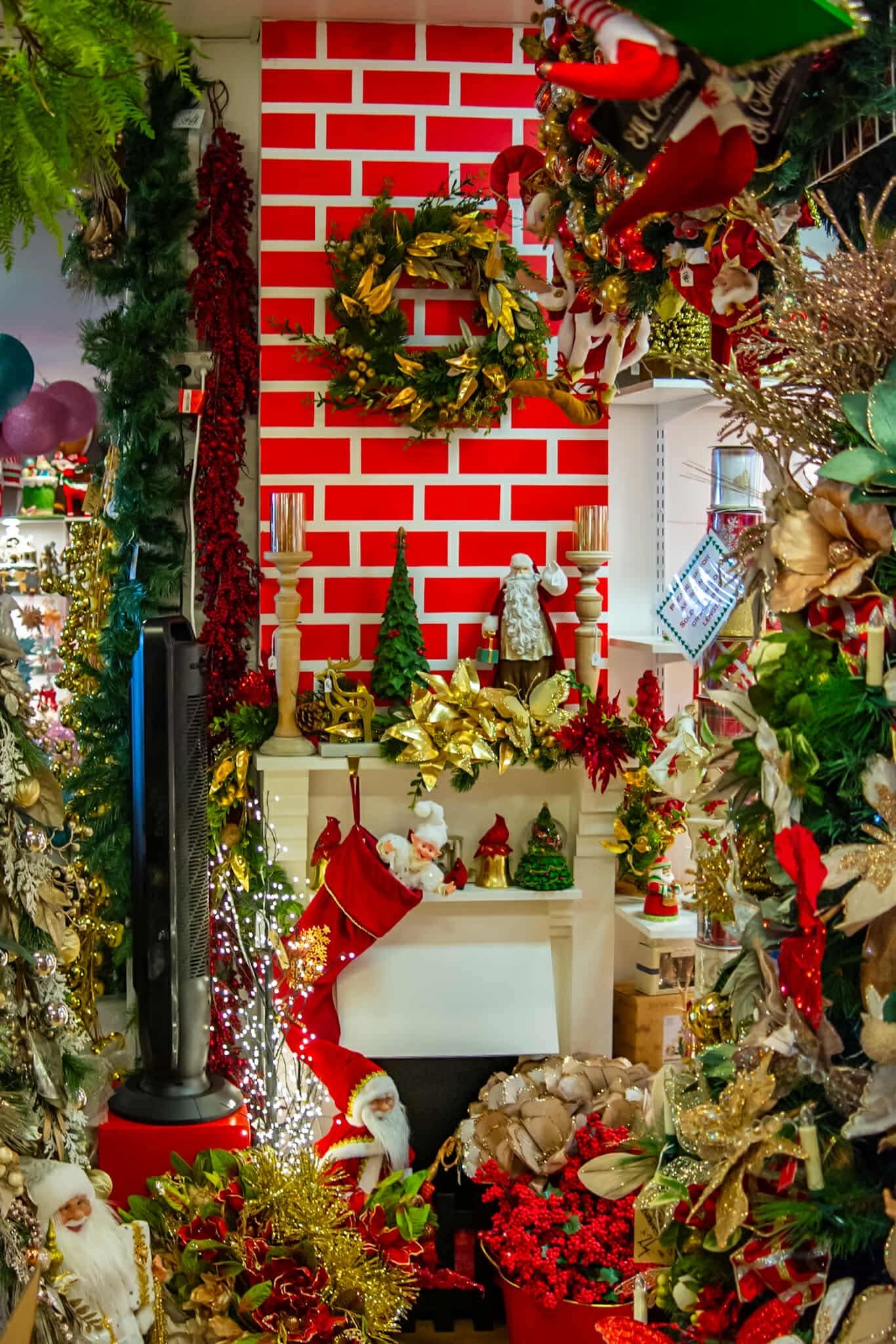 A room filled with lots of christmas decorations and a fireplace.