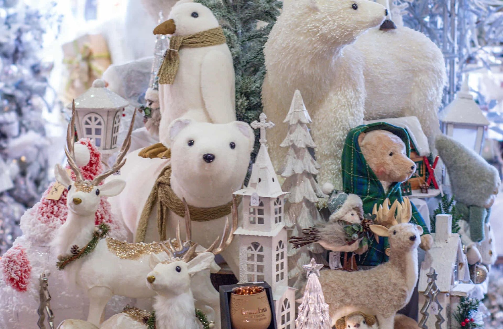 A bunch of stuffed animals are sitting on top of each other on a table.