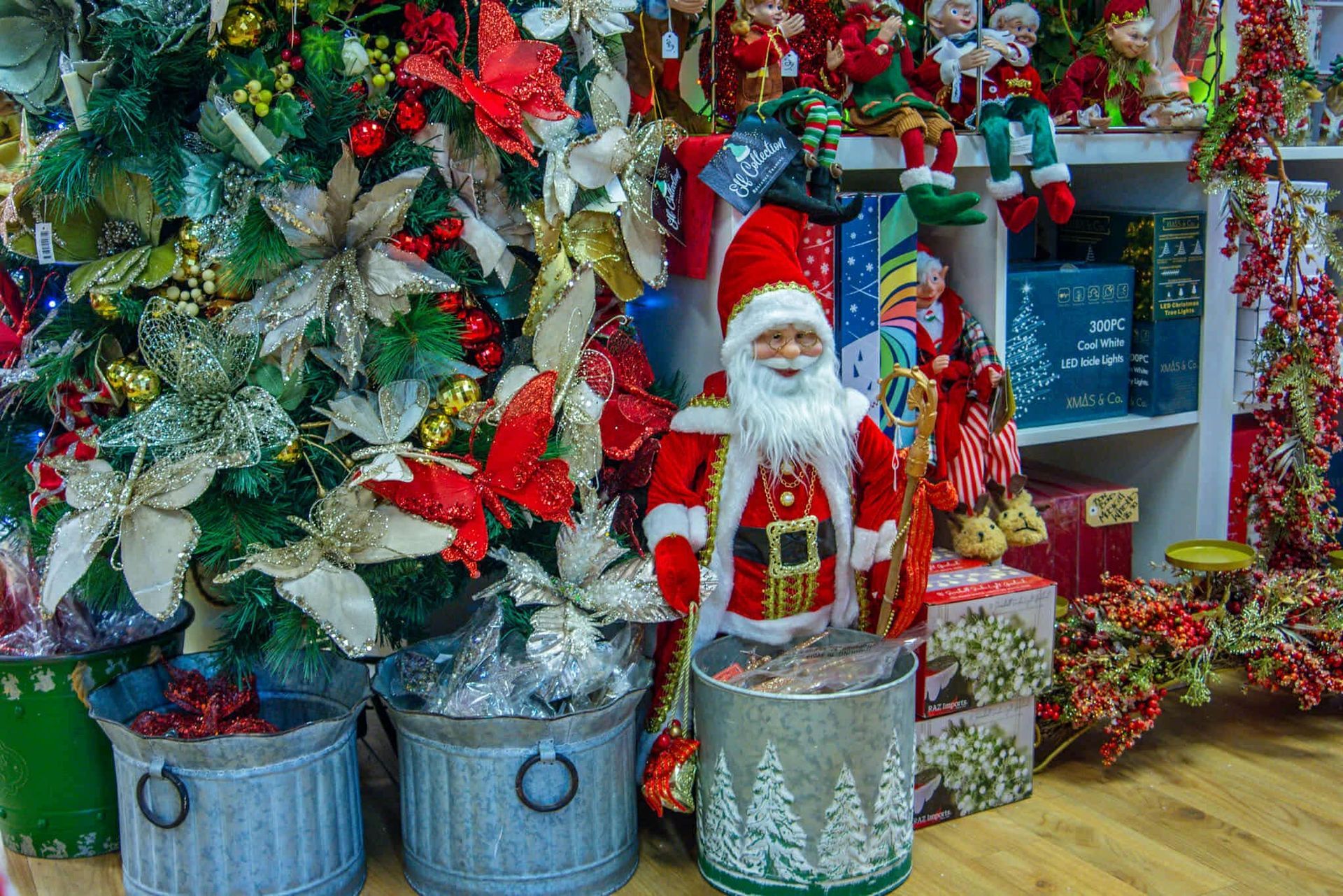 A christmas tree with a santa claus figurine in front of it.