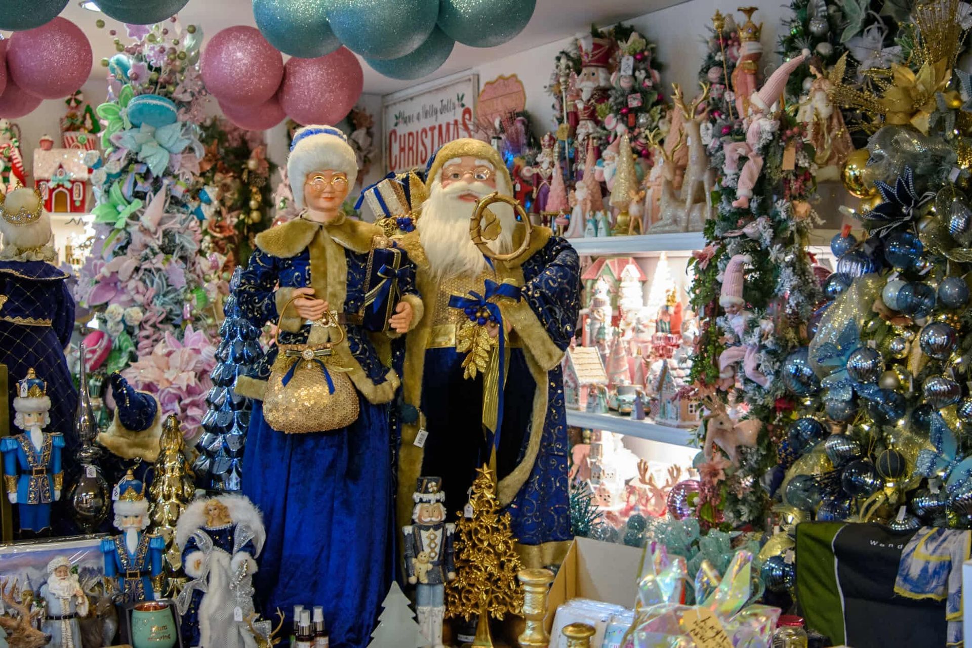 A room filled with lots of christmas decorations including a statue of santa claus