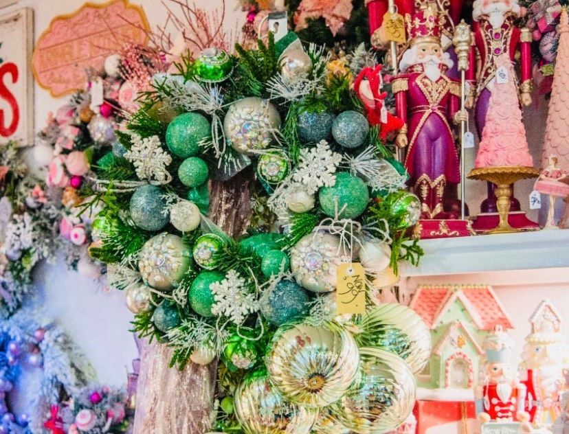 A christmas wreath is sitting on a mantle next to a display of nutcrackers.