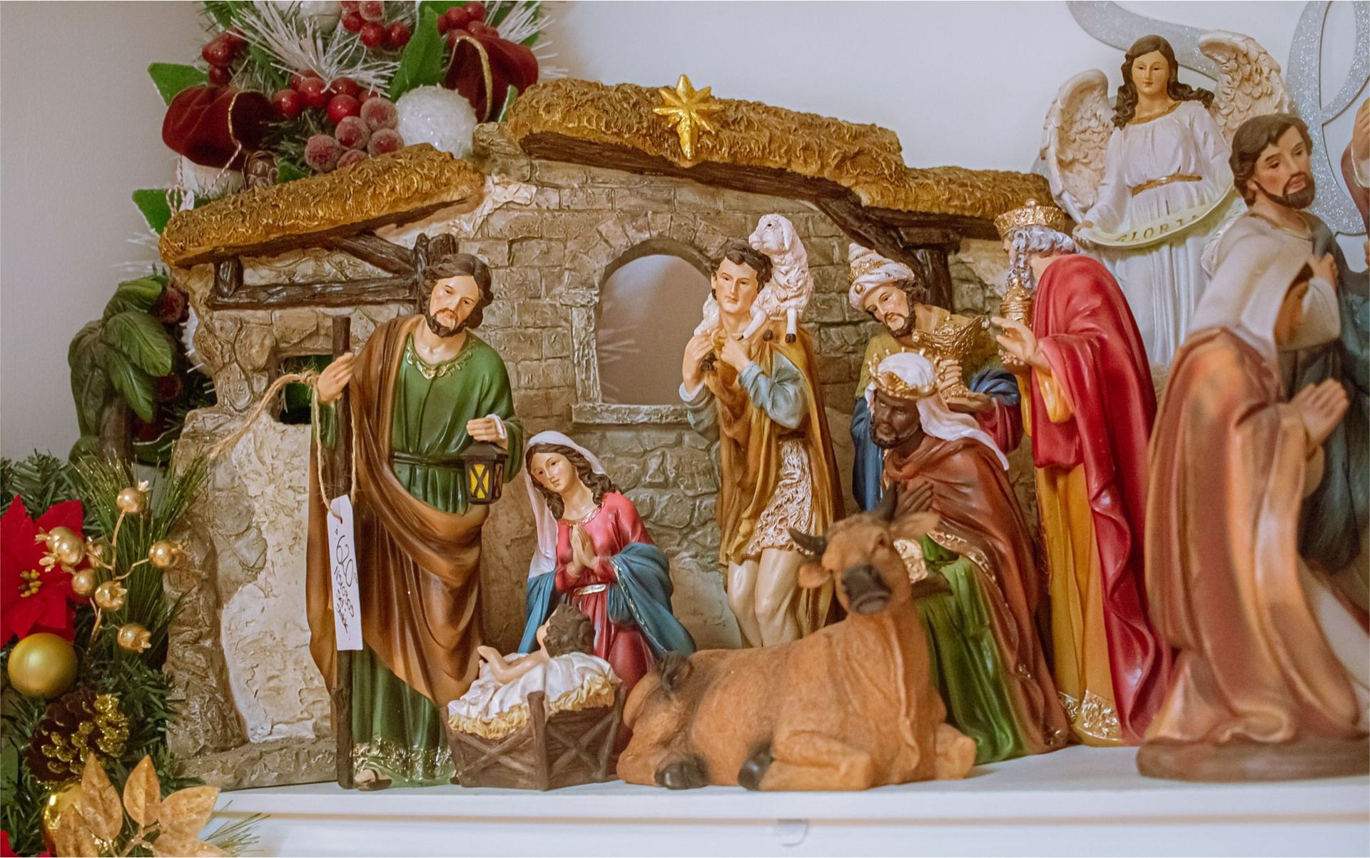 A nativity scene is displayed on a mantle.