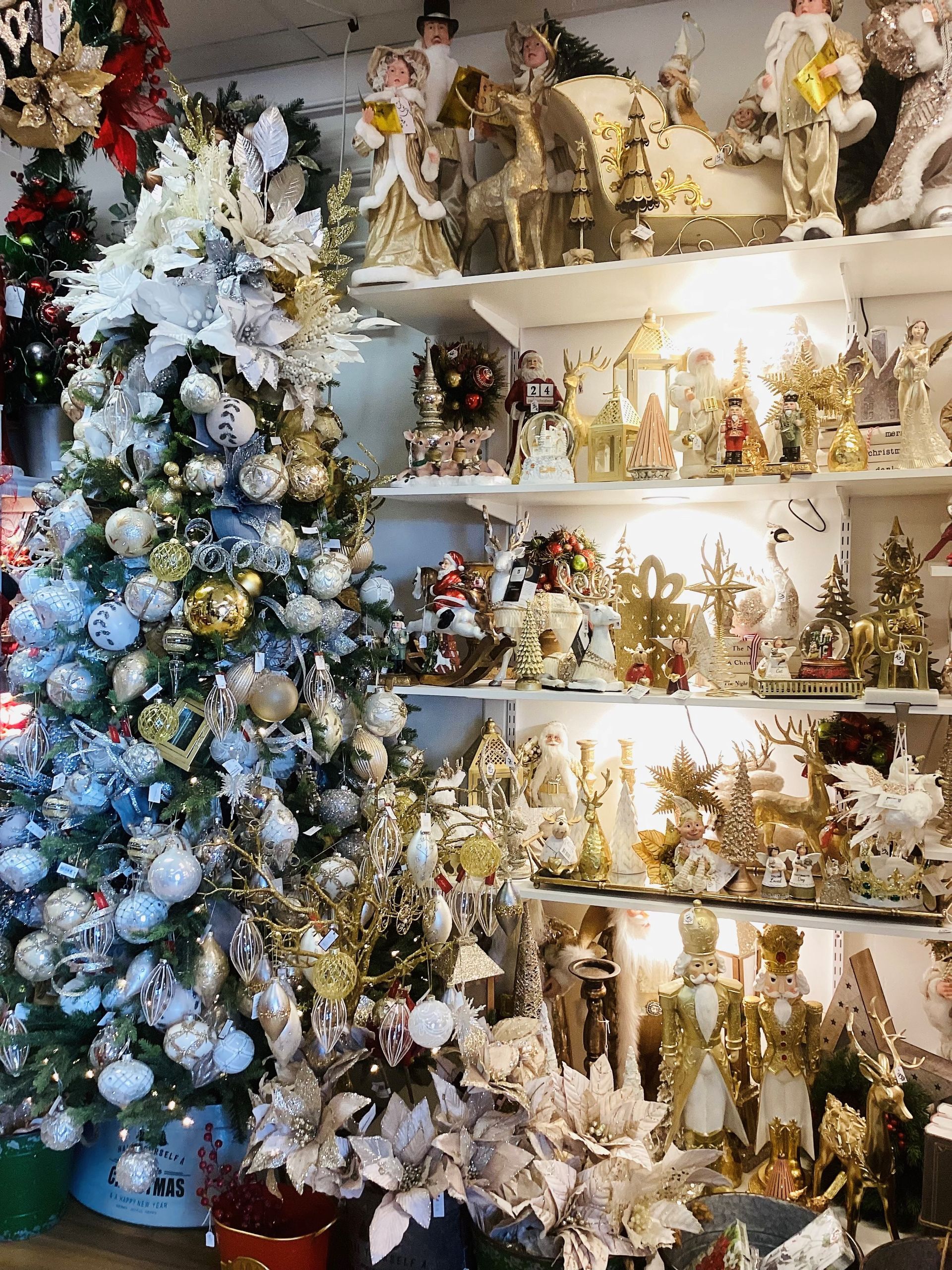 A store filled with lots of christmas decorations and trees.