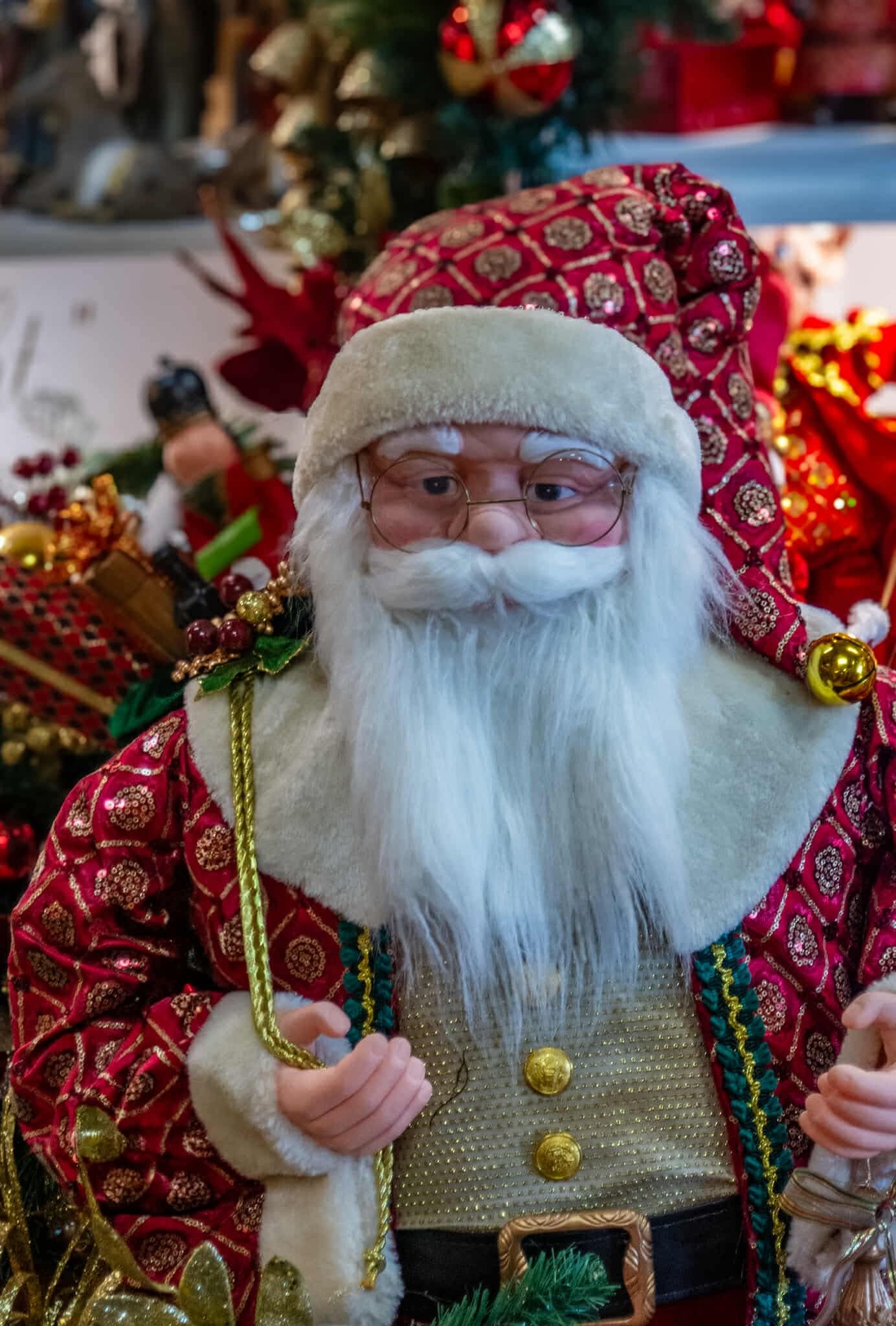 A close up of a santa claus figurine holding a bag of gifts.
