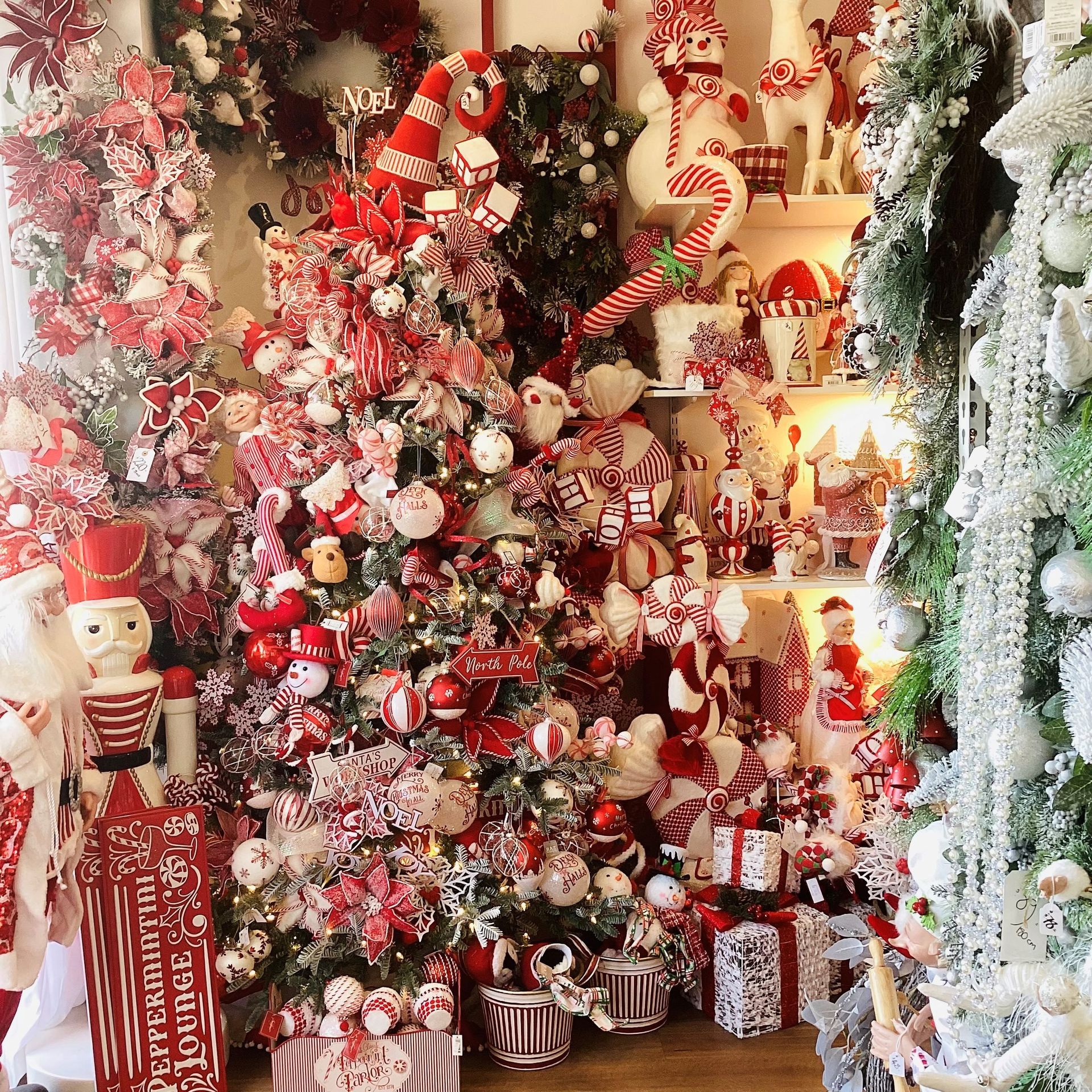 A room filled with lots of christmas decorations and trees