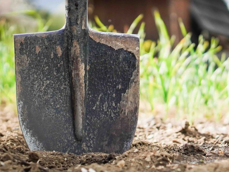 a shovel stabbed in the ground.