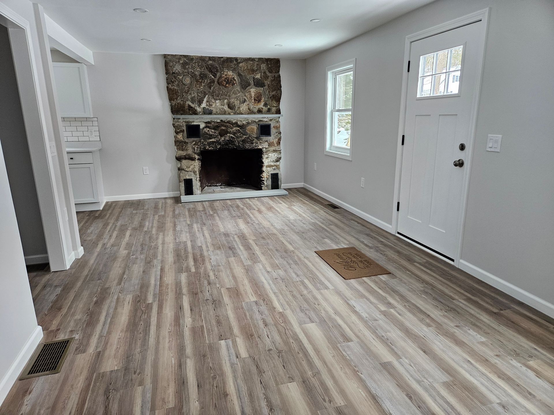A construction worker is holding a tape measure and a hard hat.