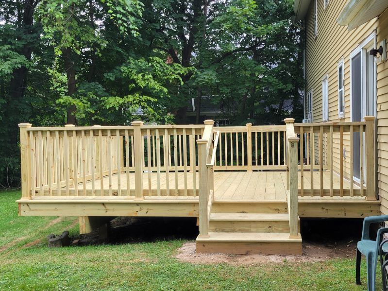 A group of construction workers are building a deck over a swimming pool.