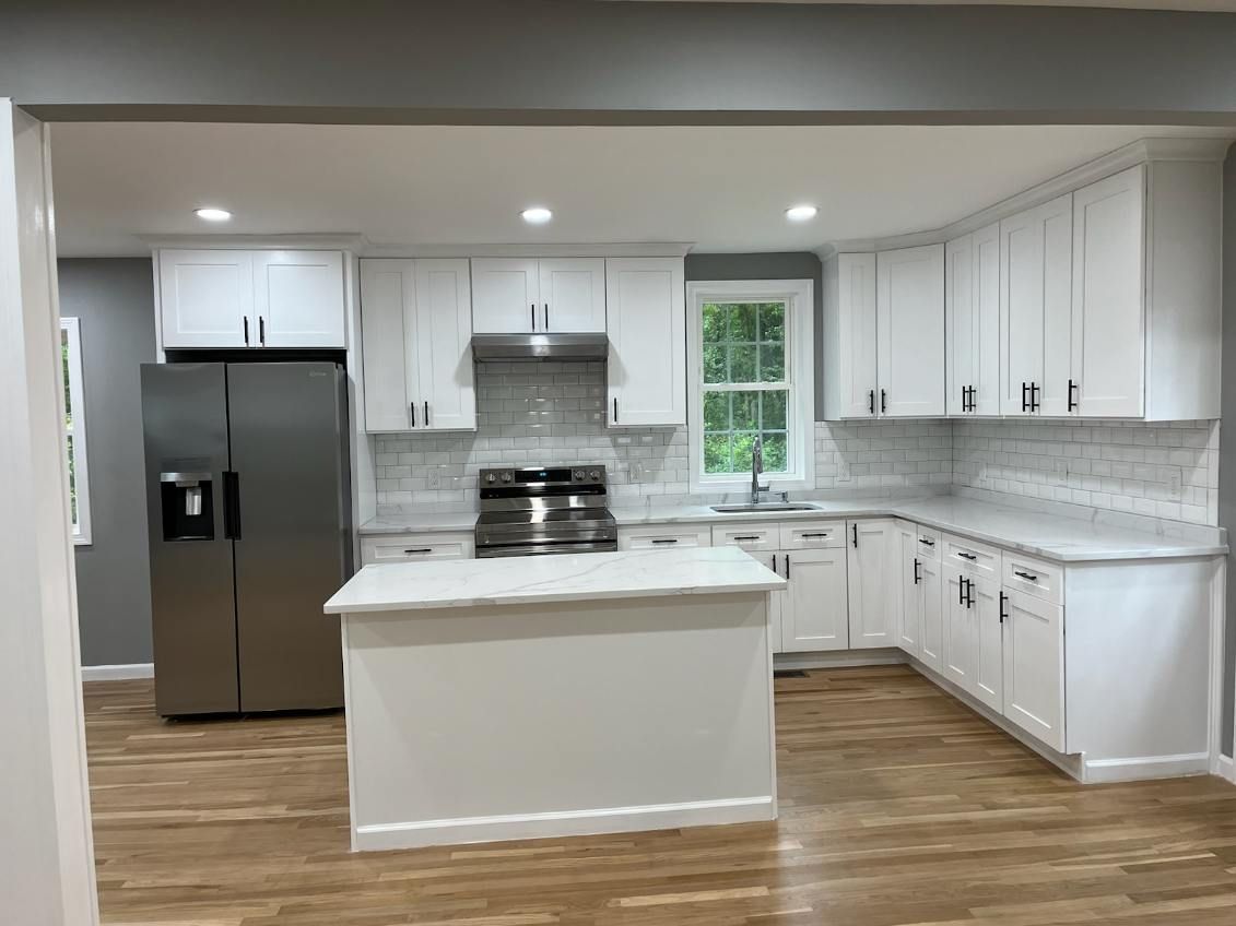 A kitchen under construction with a large island in the middle.