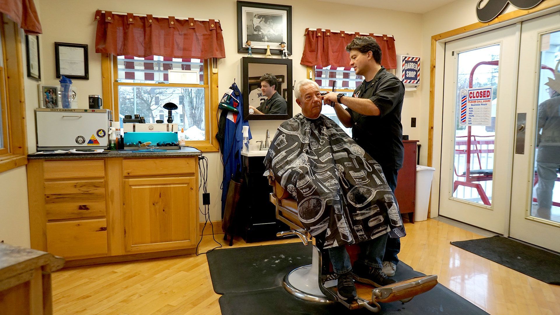 A retired gentlemen receives a traditional haircut from a professional barber in Harbor Springs, Michigan.