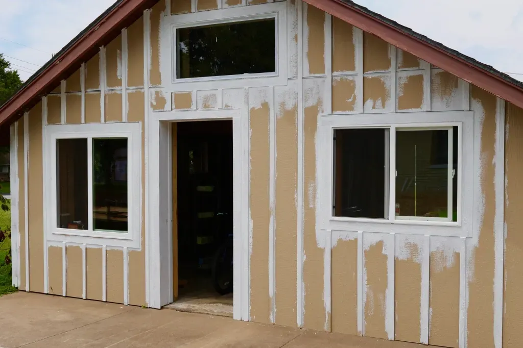 A house with a lot of windows is being built.