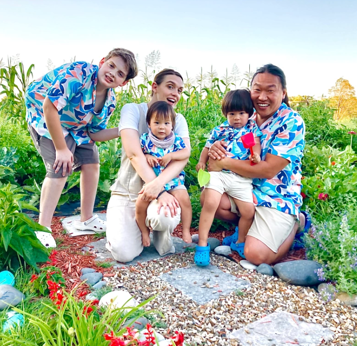 A group of people are posing for a picture in a garden.