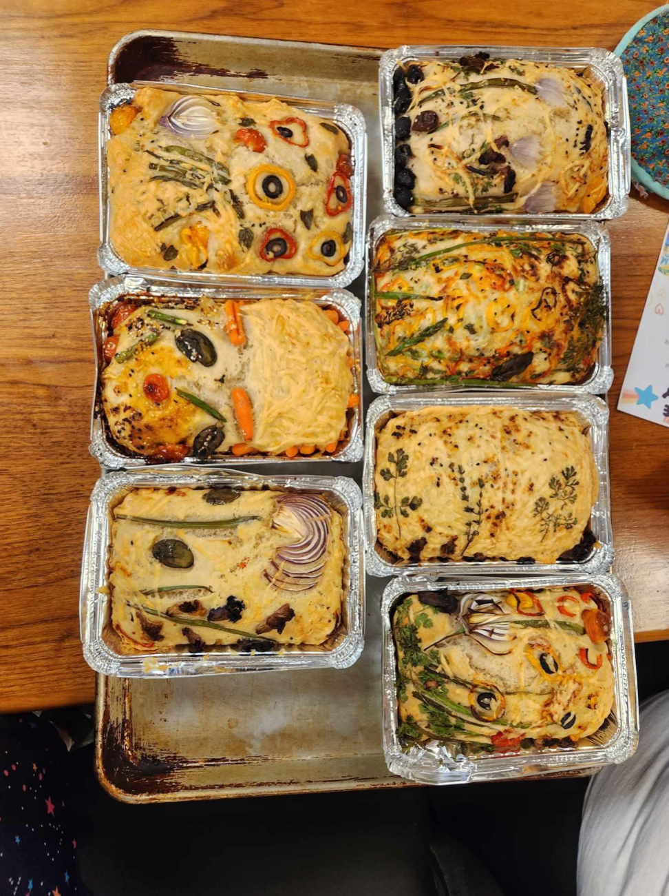 A bunch of containers of food are sitting on a table.