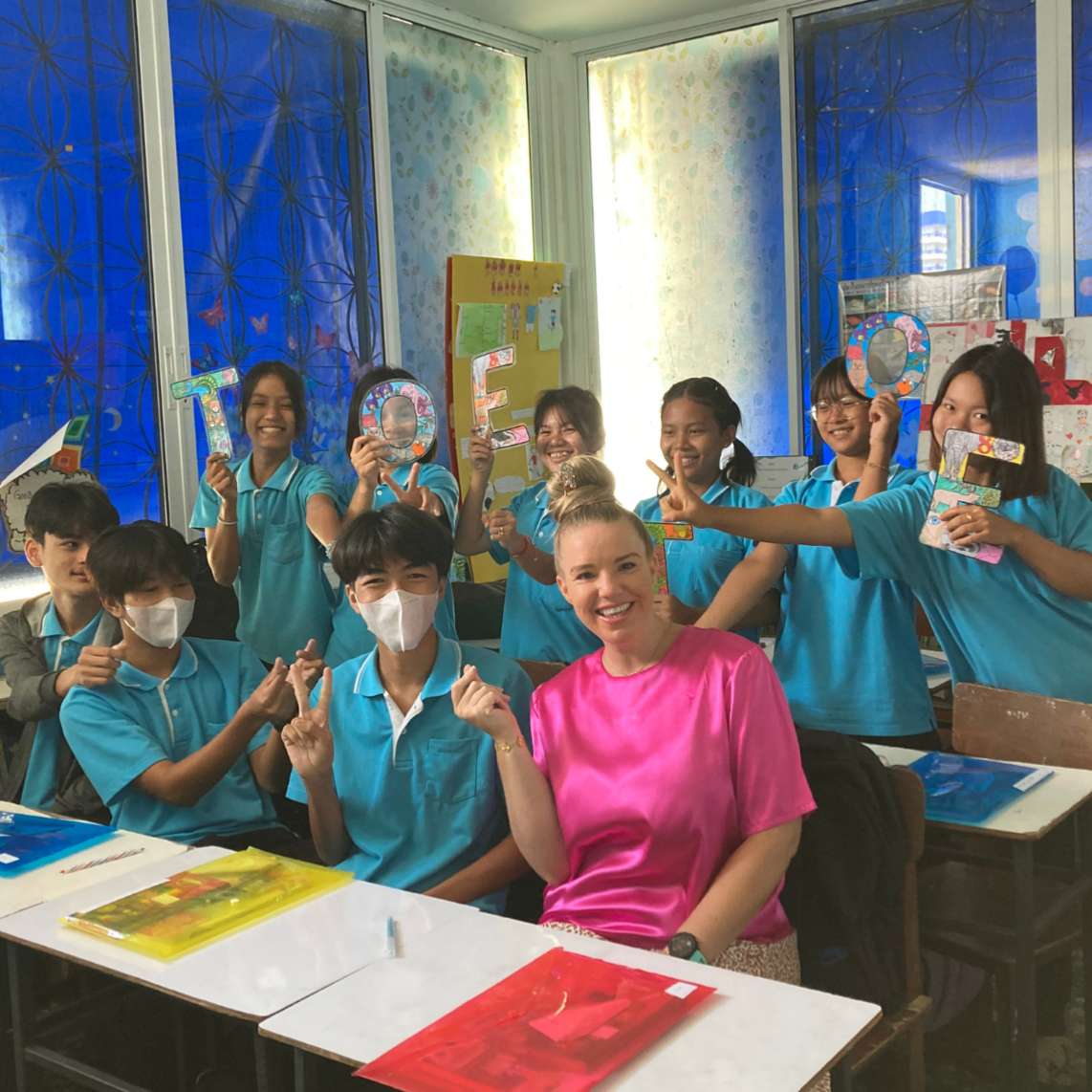 A group of children are posing for a picture in a classroom