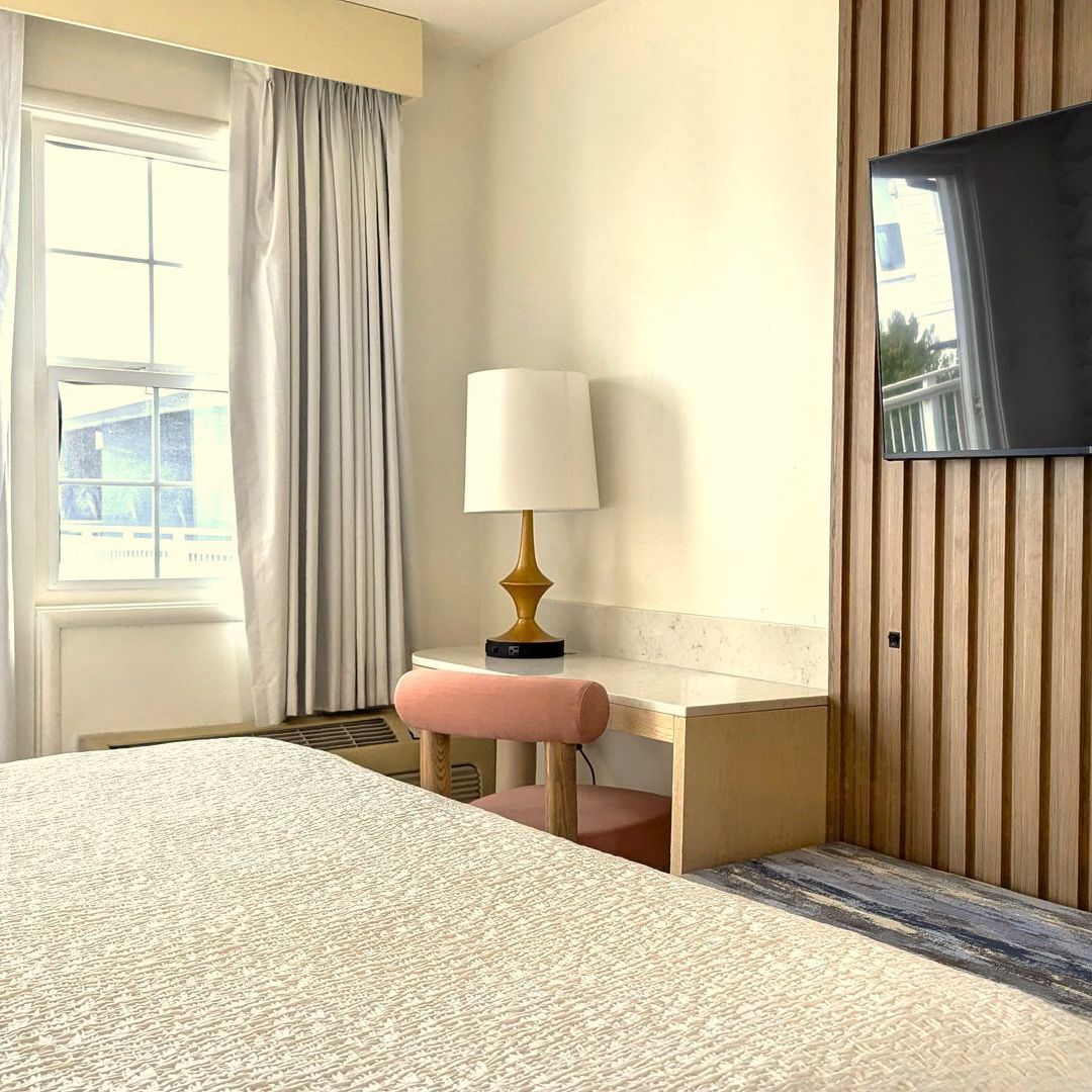 Lamp on desk next to an open window