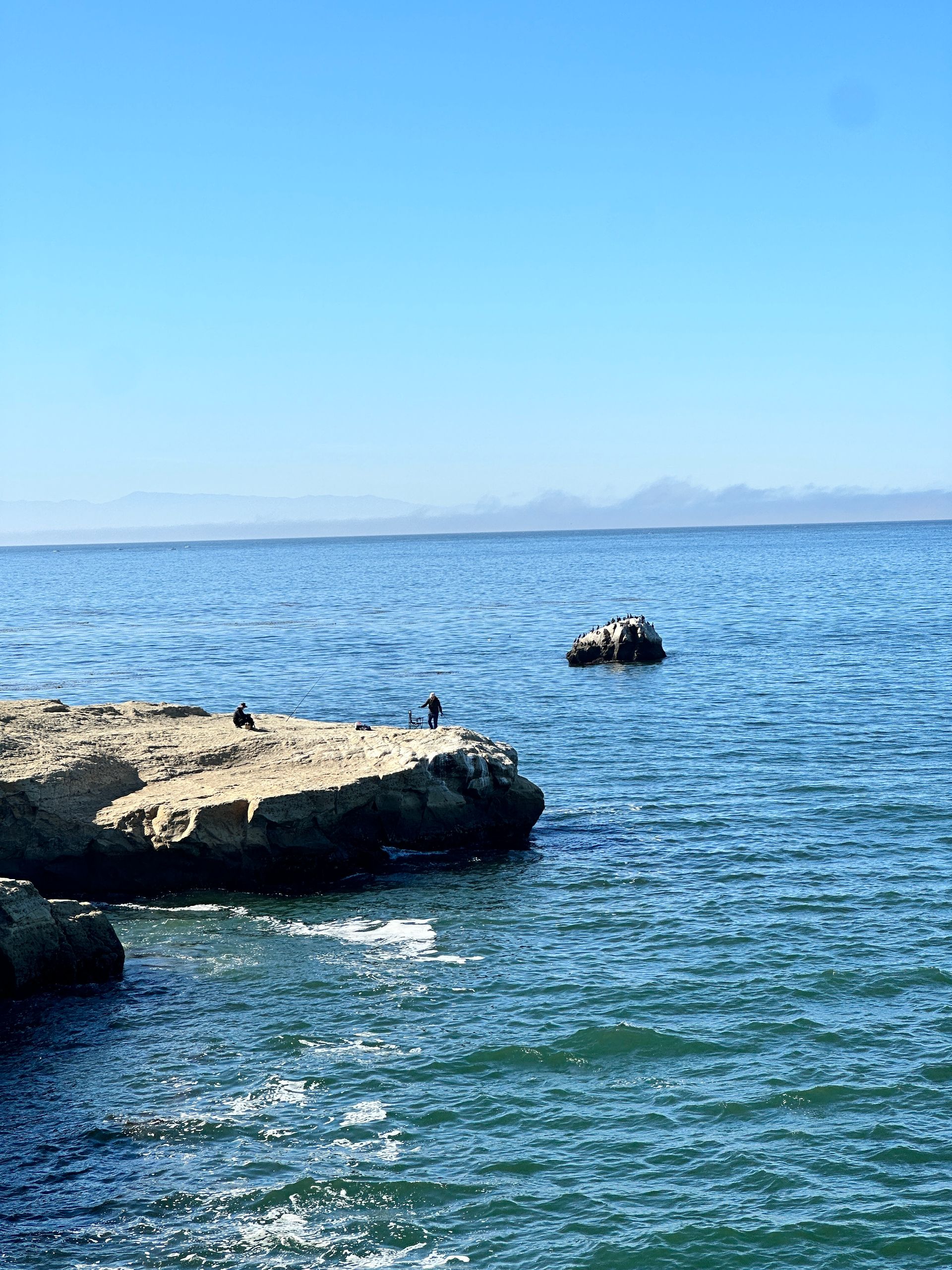 large rocks sticking up out of the ocean
