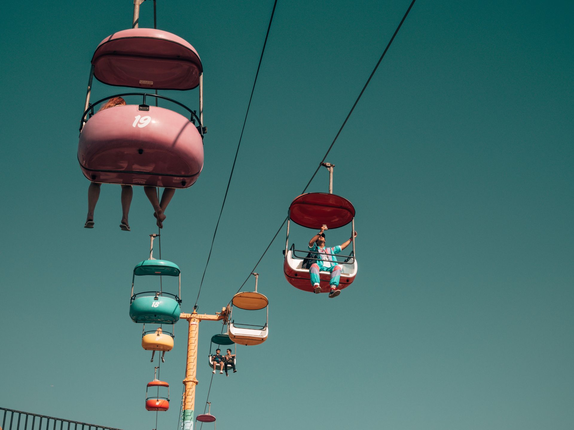Sky Glider ride at Santa Cruz Beach Boardwalk with people riding it