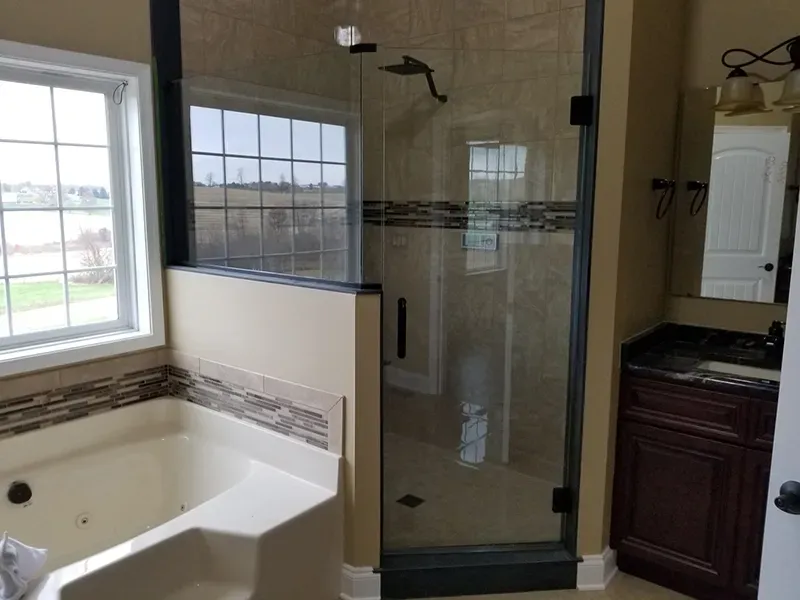 A neutral-toned bathroom with a corner jetted tub, a glass-enclosed shower, and a dark wood vanity with a mirror.