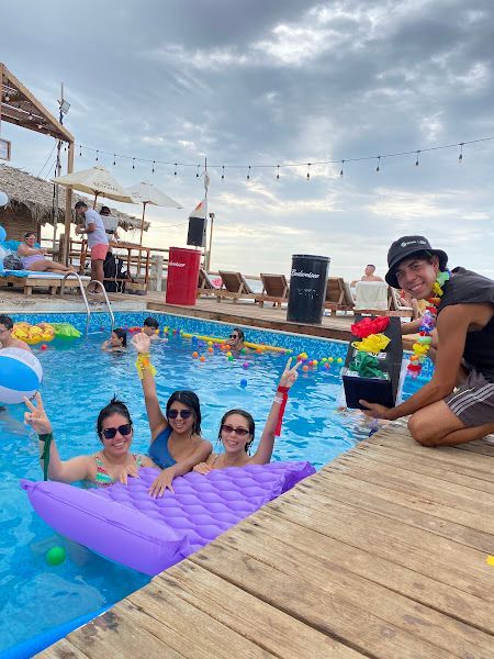 A group of people are posing for a picture in a swimming pool.