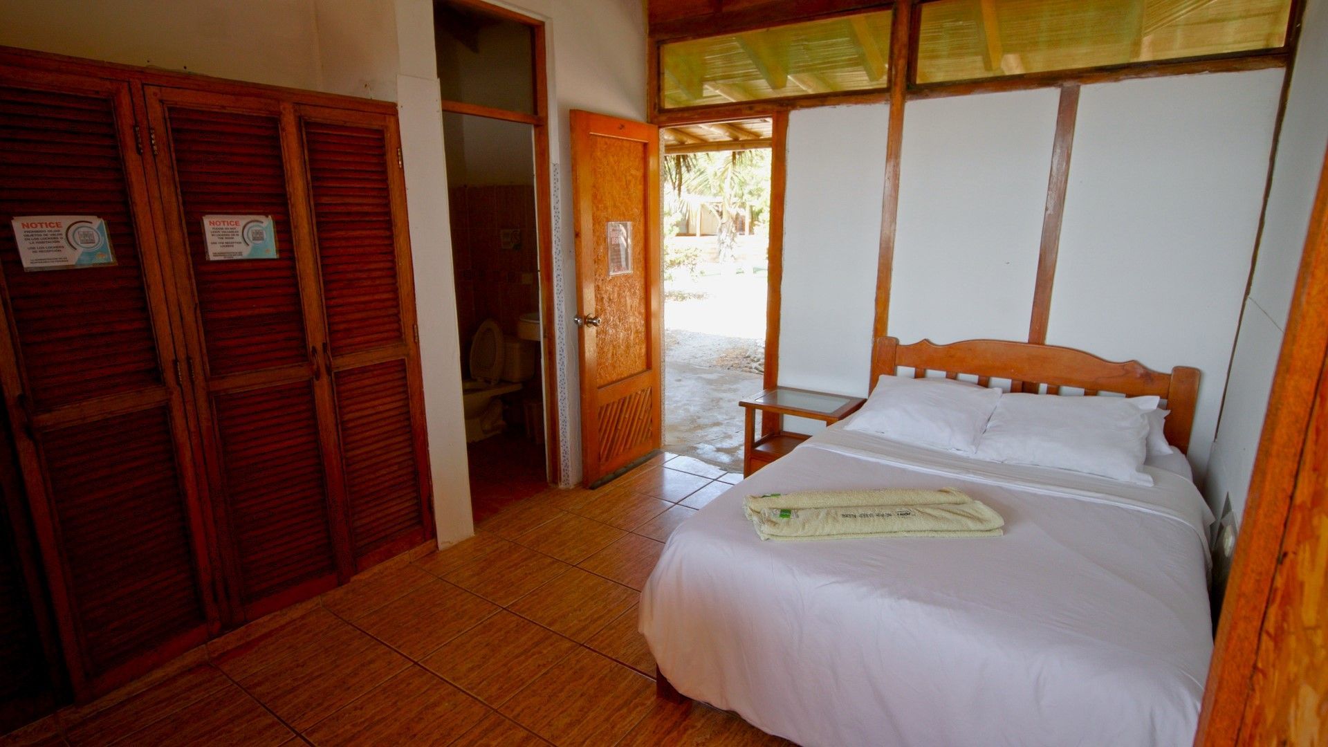 A bedroom with a bed , closet , and door.