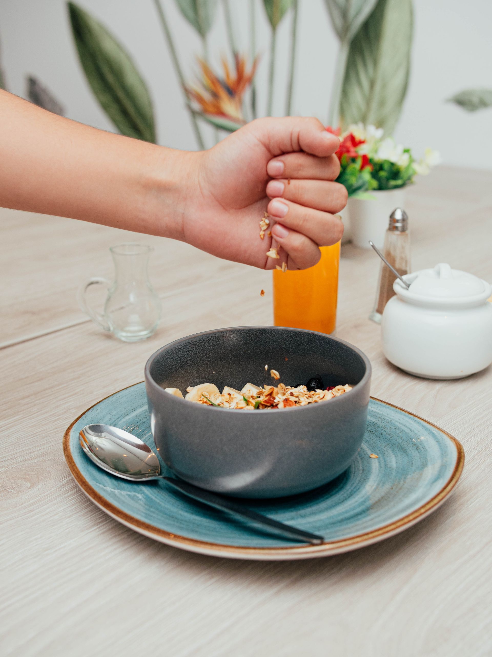 A person is pouring milk into a bowl of cereal