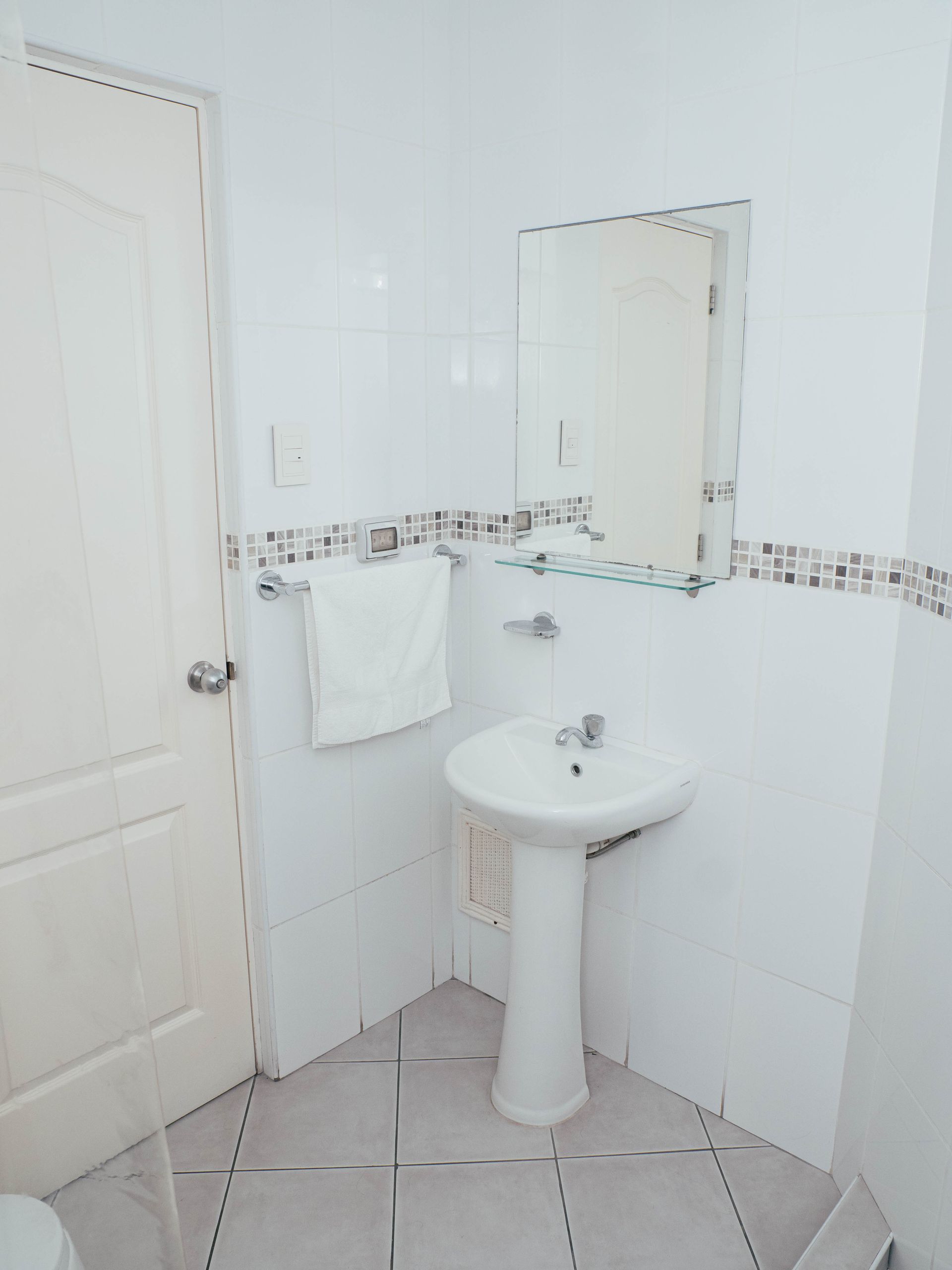 A bathroom with a sink , toilet and mirror