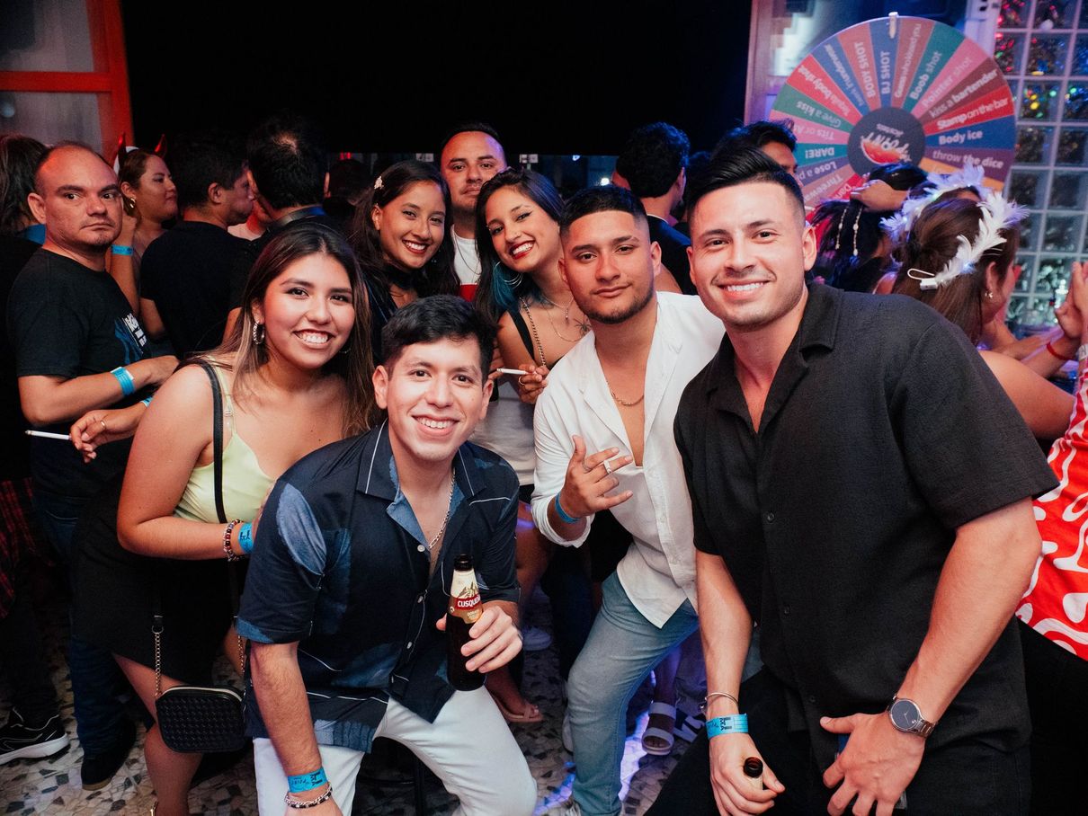 A group of people are posing for a picture at a party.