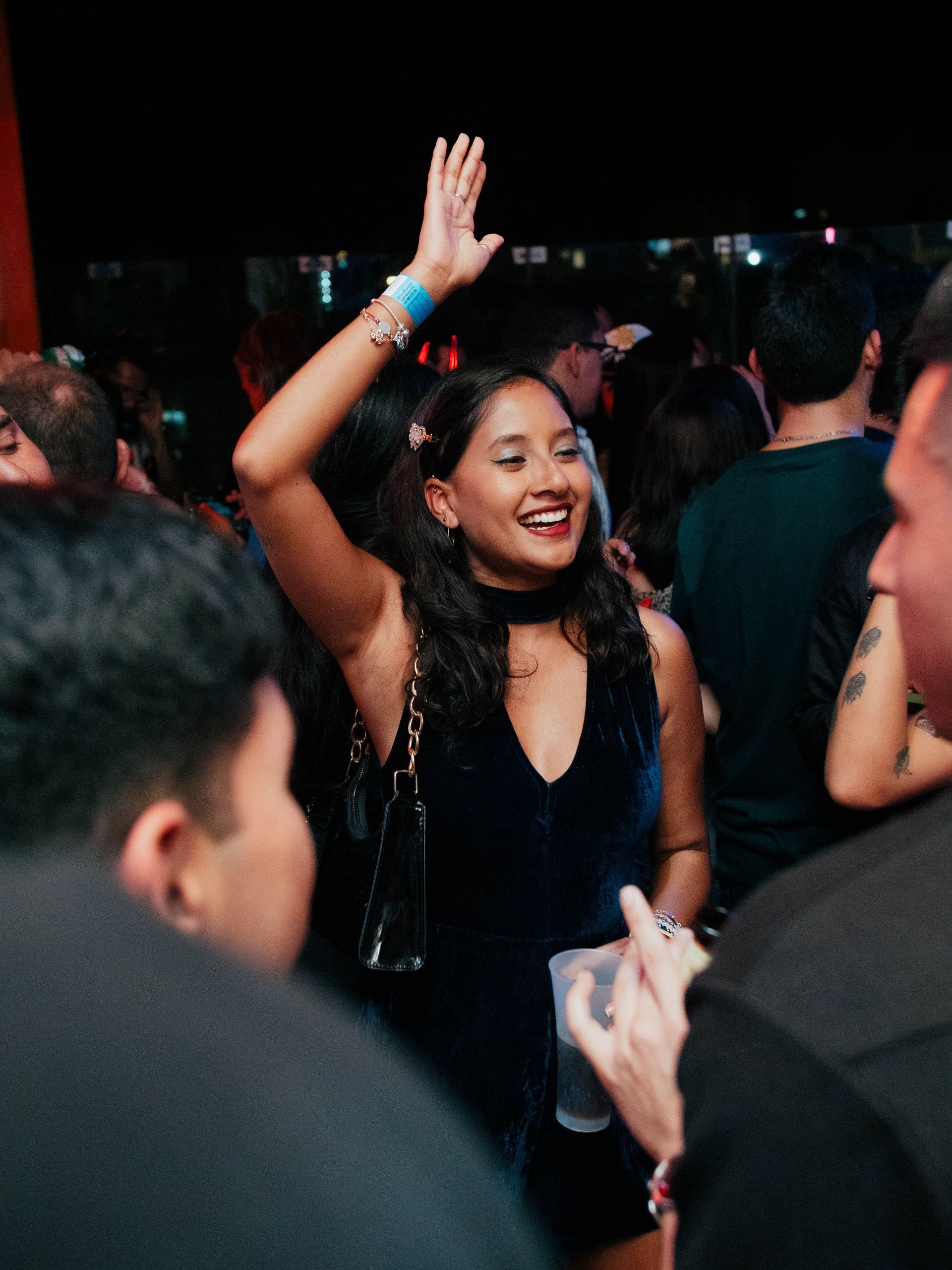A woman is dancing in a crowd of people at a party
