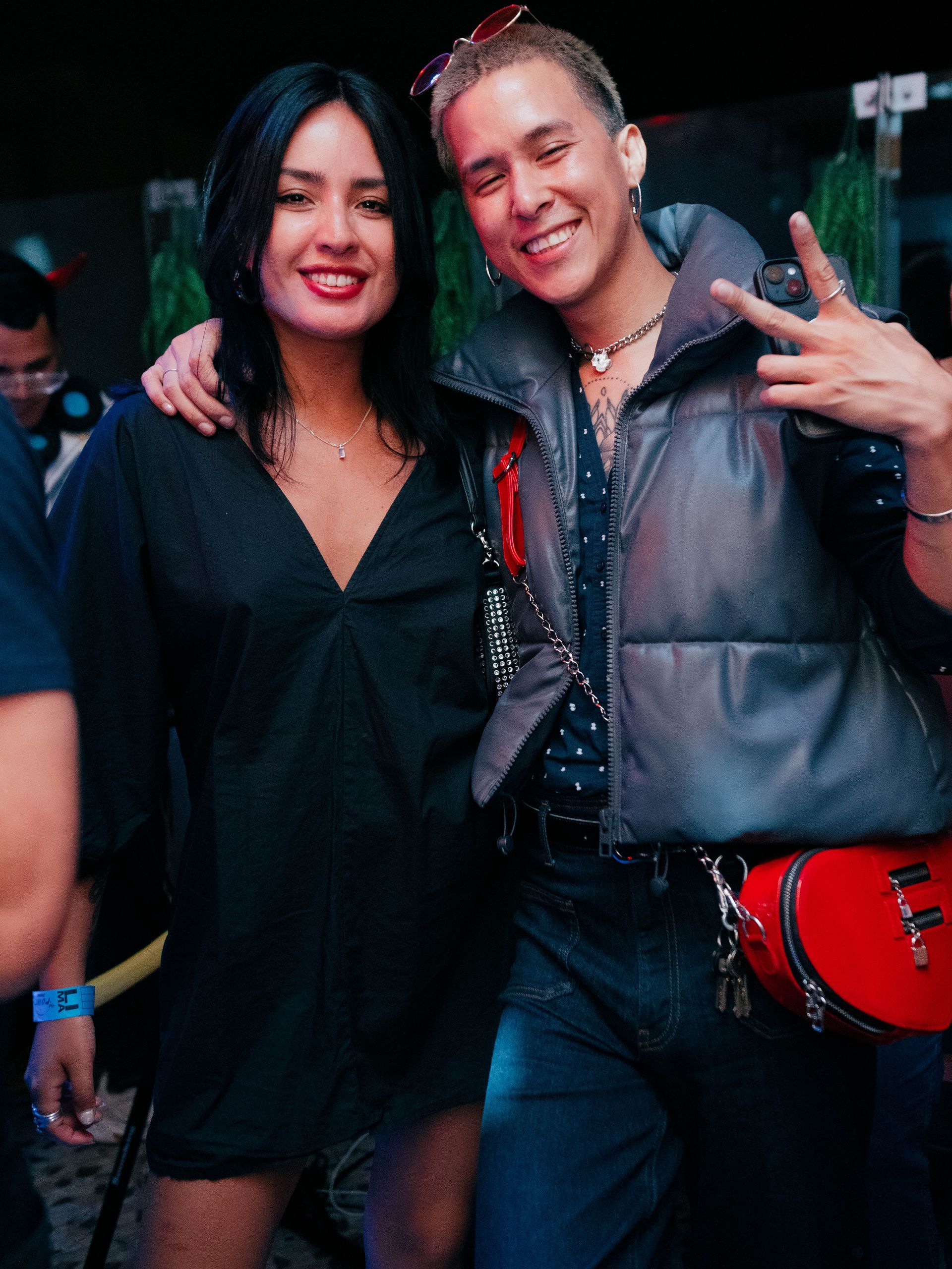 A man and a woman are posing for a picture at a party