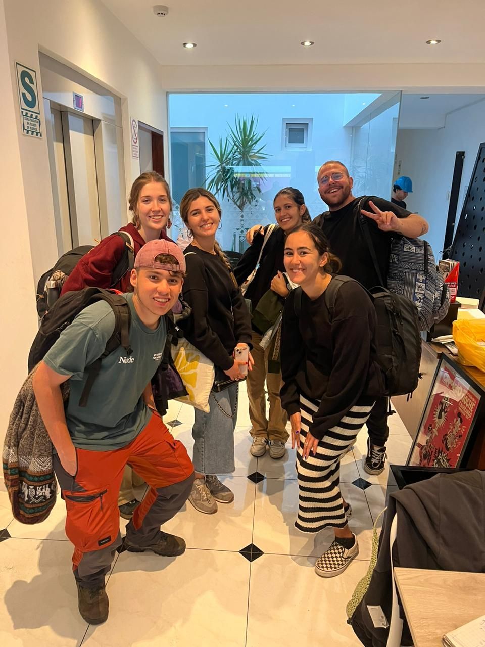 A group of people are posing for a picture in a room.