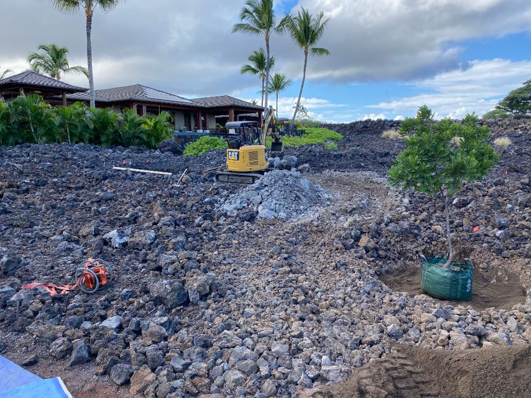 A bulldozer is sitting on top of a pile of rocks doing excavation