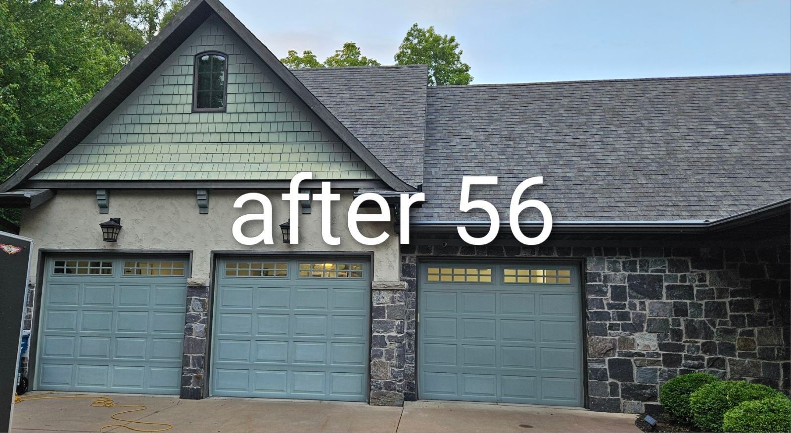 Front of a house with three blue garage doors and text “after 56” overlaid.