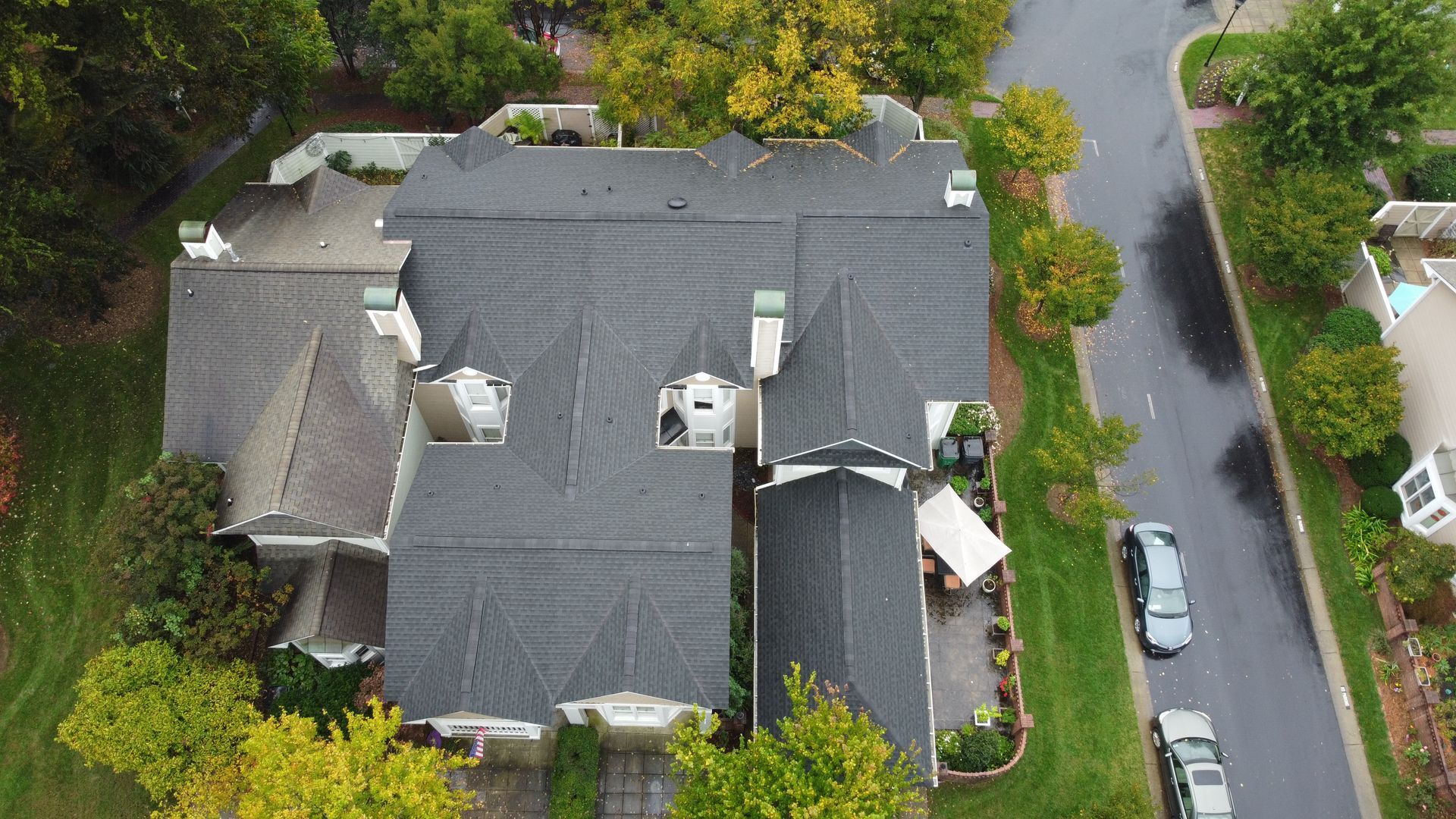An aerial view of a large house in a residential neighborhood.