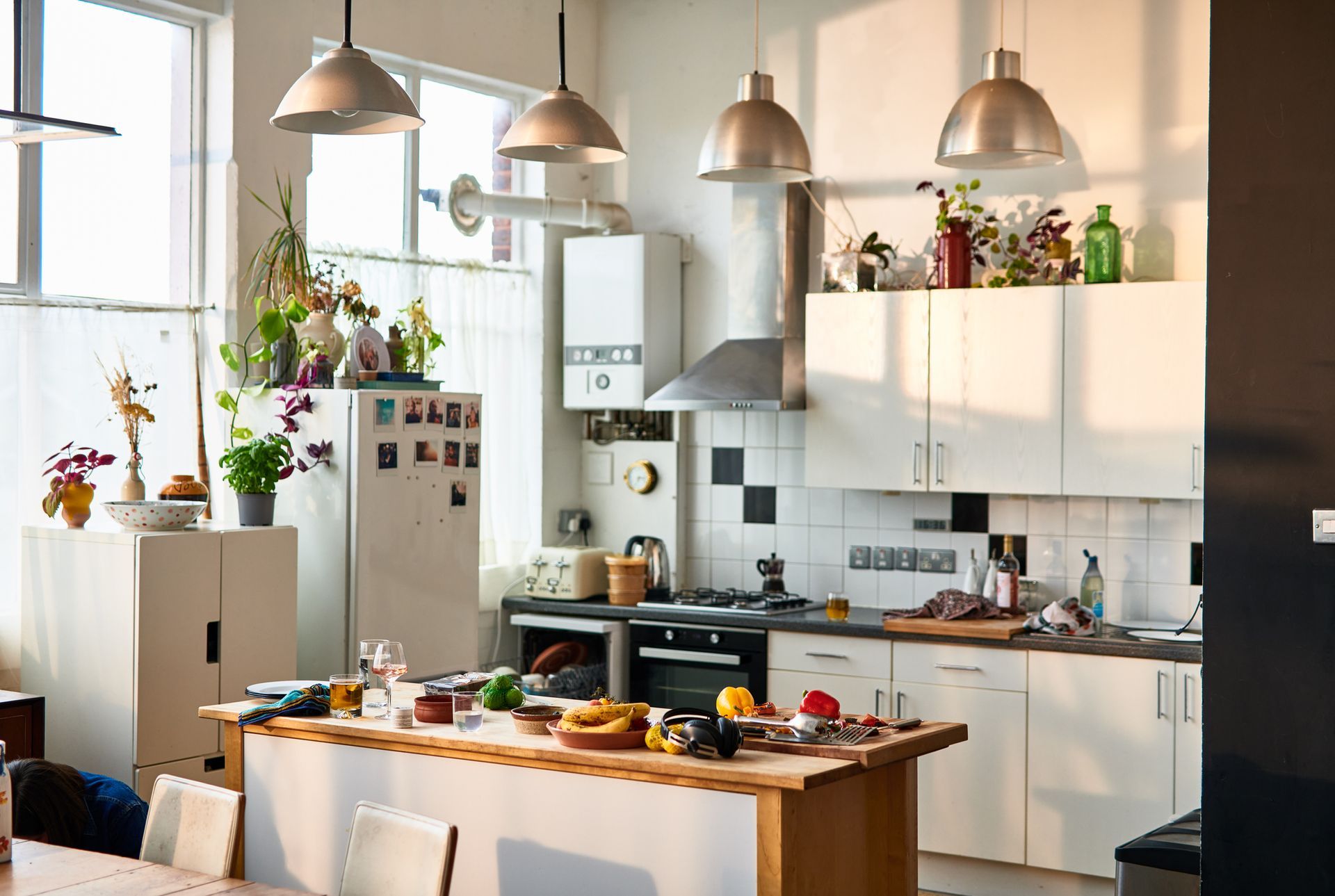 A kitchen with a table and chairs and a refrigerator.
