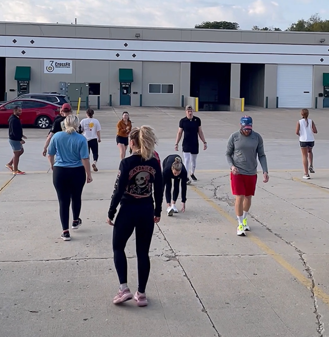 Person receiving lumbar spine treatment with kinesiology tape.