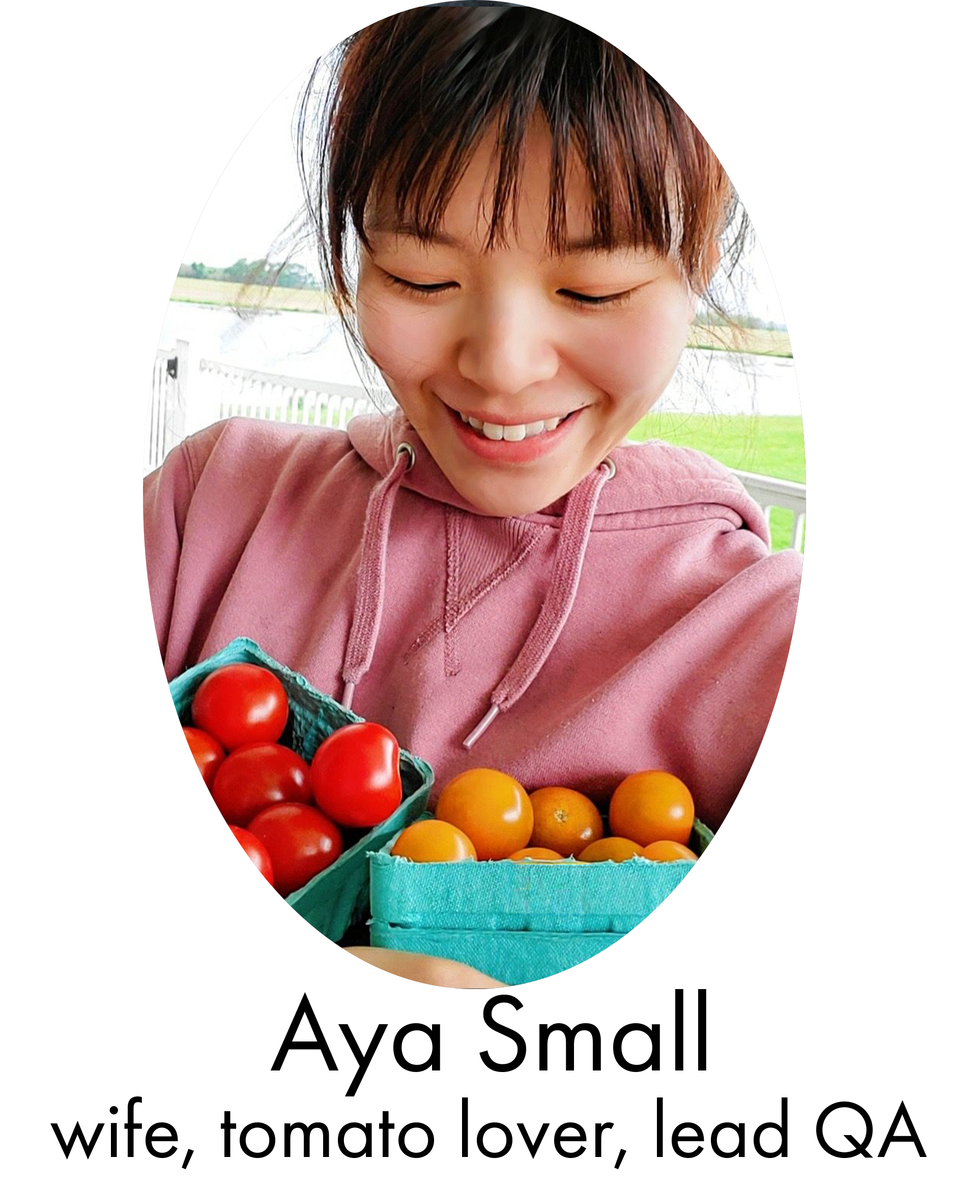 Aya smiling and looking at a box of her favorite tomatoes