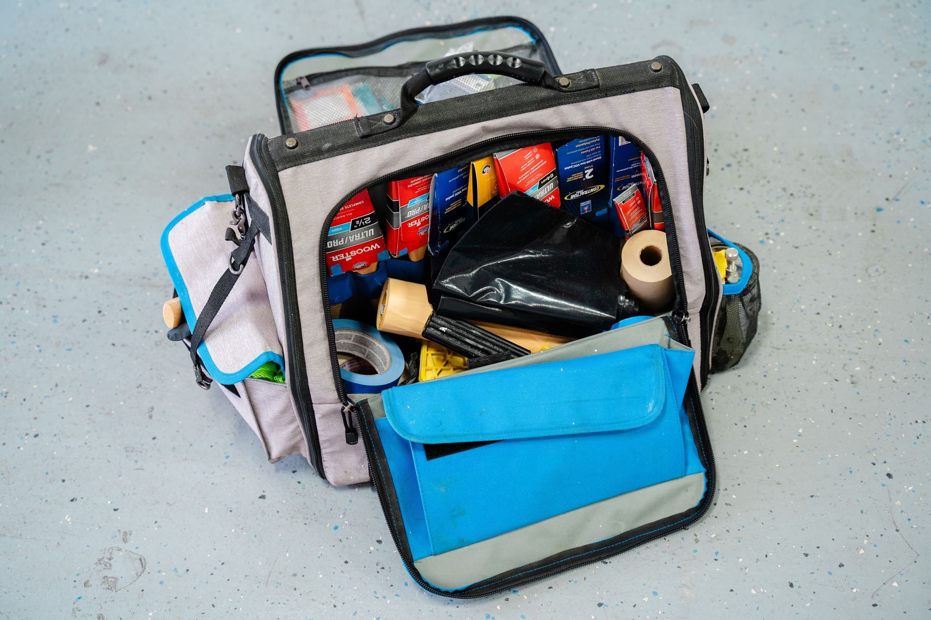 A painter's essentials when going to every job site. They carry this bag with them full of supplies.