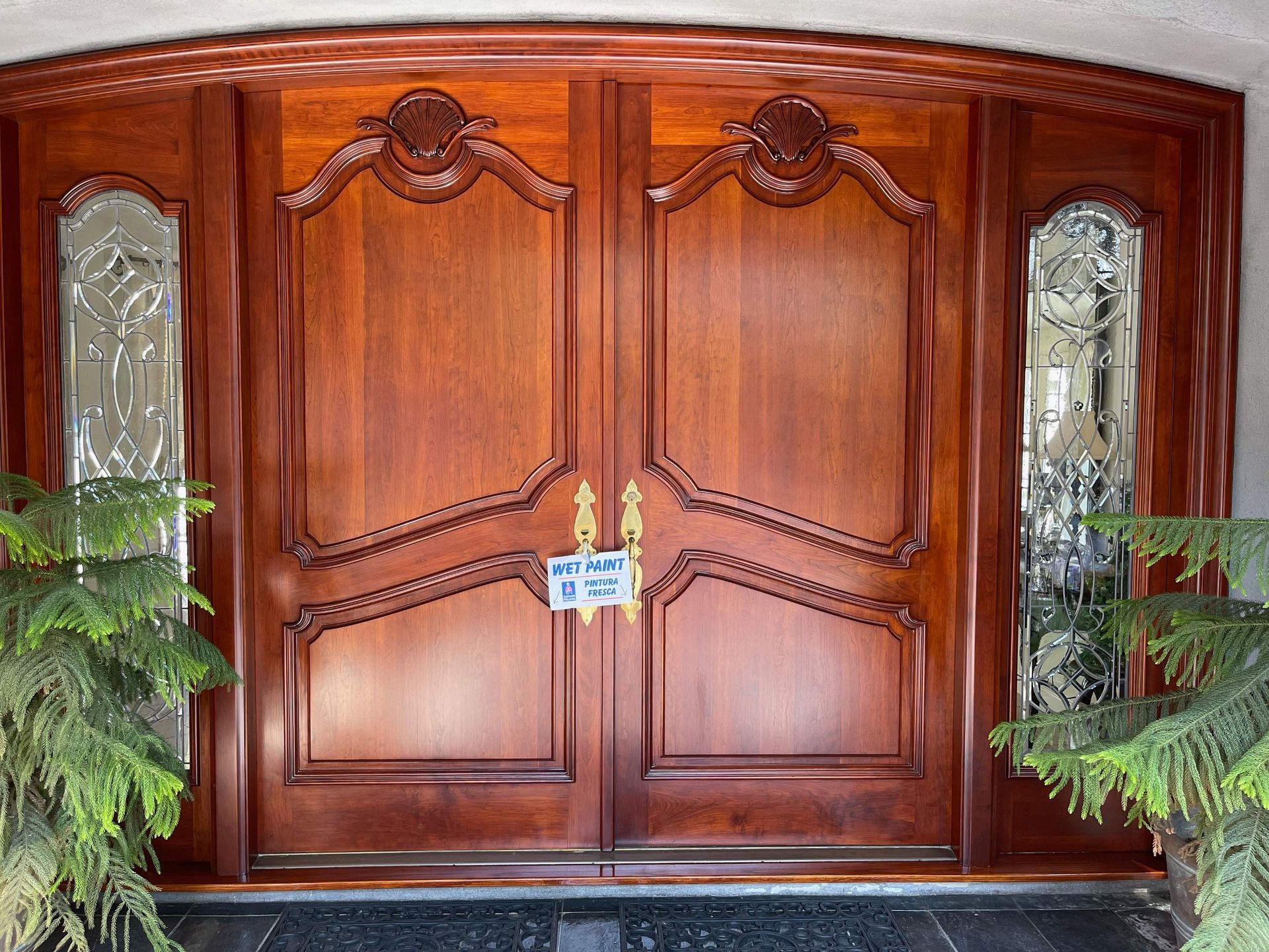 Stunning, freshly refinished, wooden double-door front door.