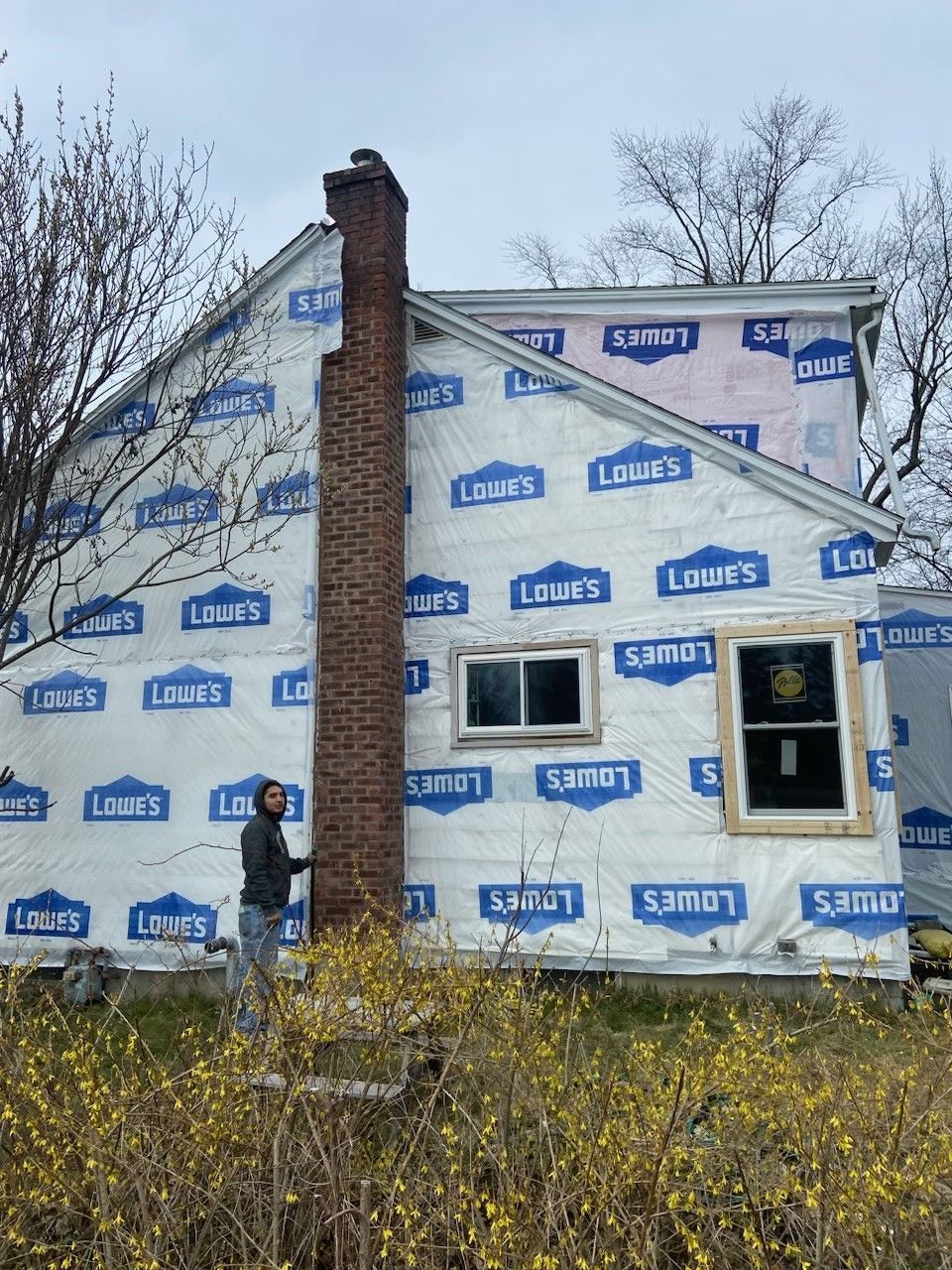 A man is standing in front of a house that is being remodeled.  - Kingston, NY - JMD Home Improvements