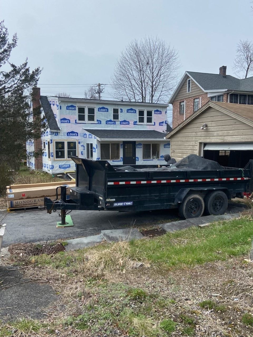 A dumpster is parked in front of a house under construction  - Kingston, NY - JMD Home Improvements
