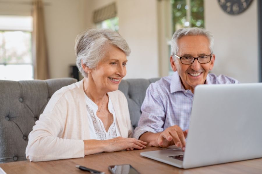 Clients researching different healthcare plans on laptop