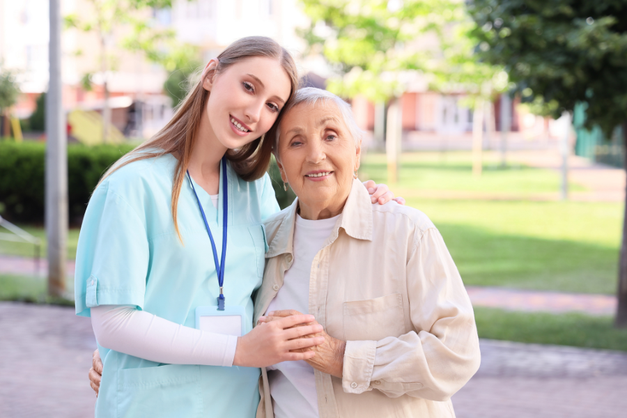 caregiver and woman tanding outside