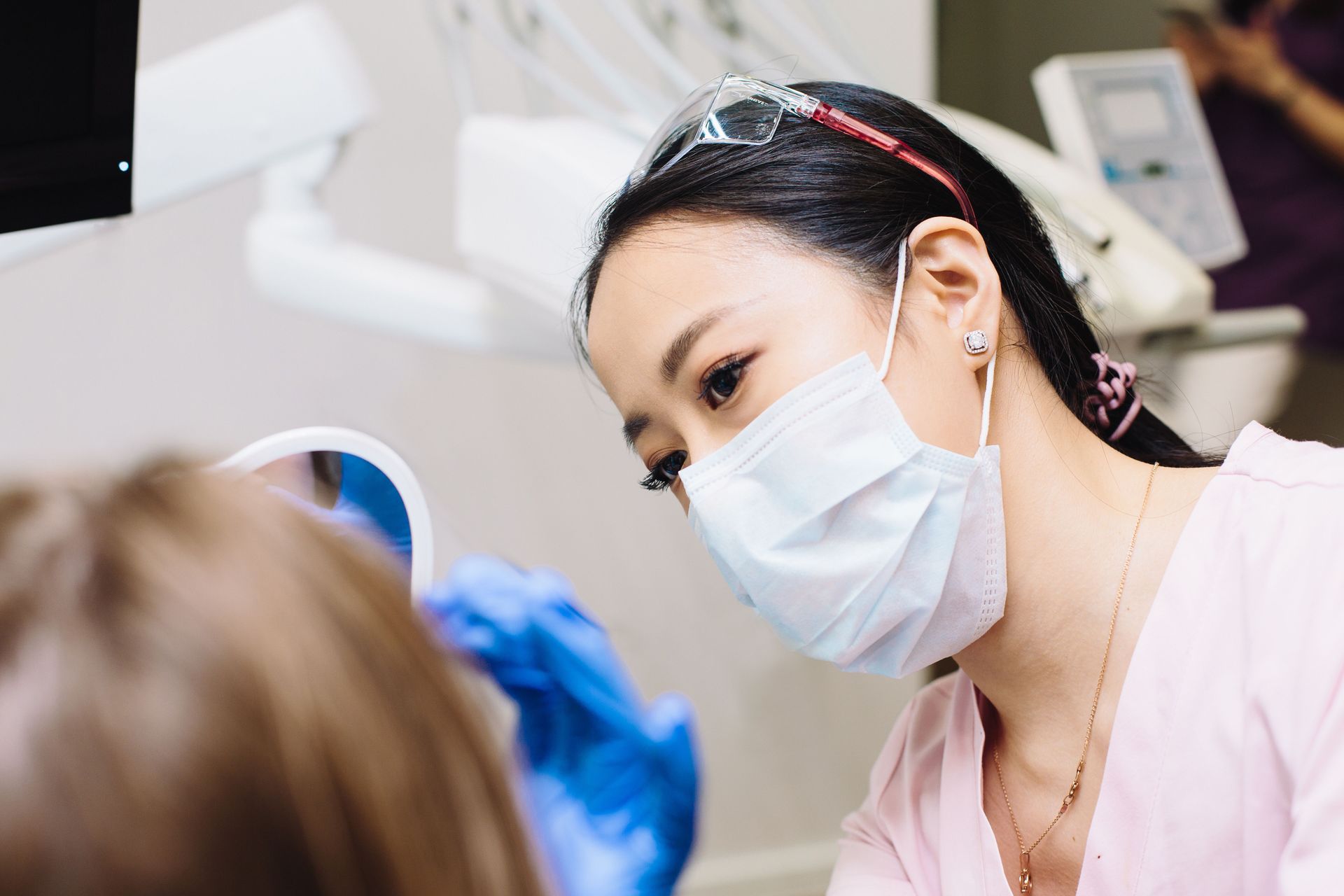 Dental hygienist using a scaler to remove tartar during a dental cleaning in Babylon NY