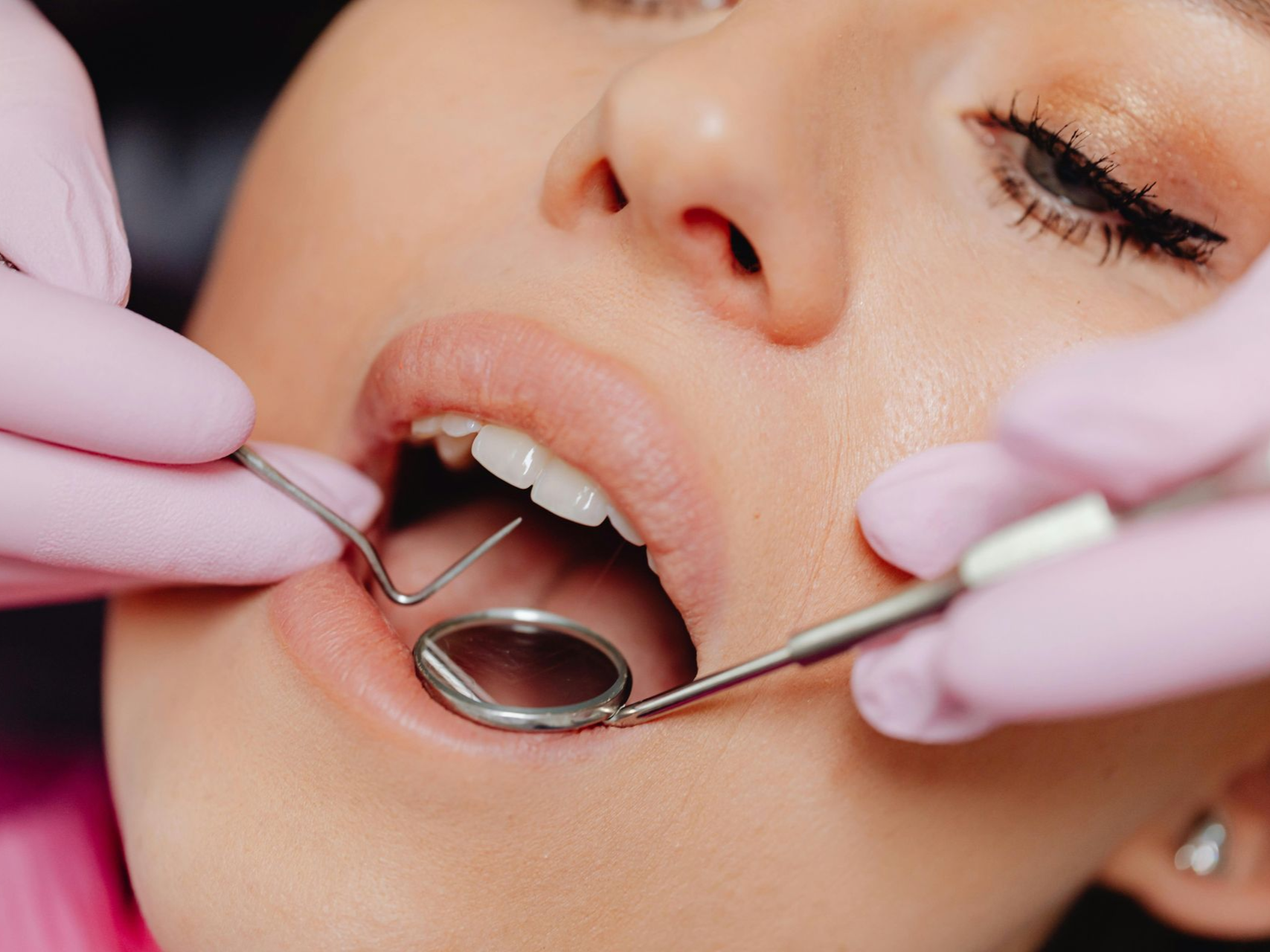 Dental hygienist performing a professional dental cleaning for an adult patient in Babylon NY