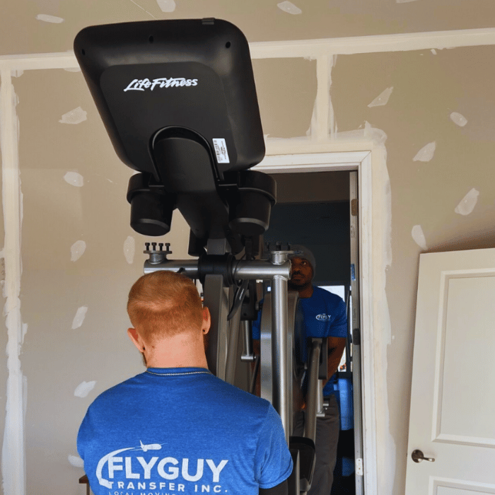 A man wearing a blue shirt that says fly guy